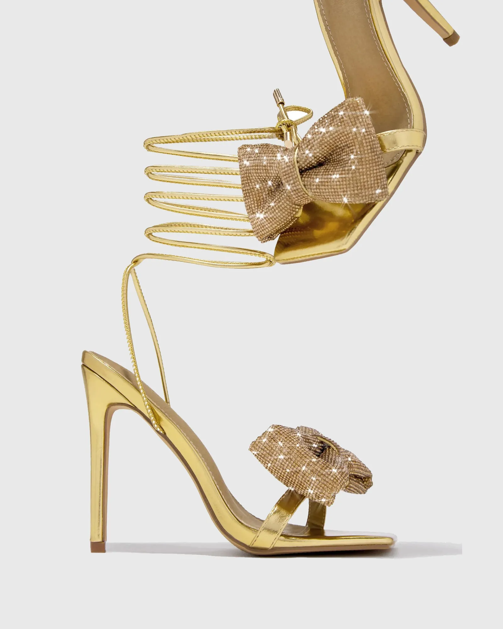 Nora Crystal Bow Lace Up Sandals In Gold